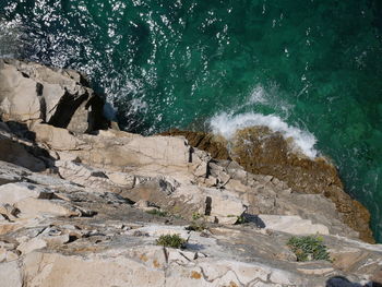 High angle view of rocks in sea