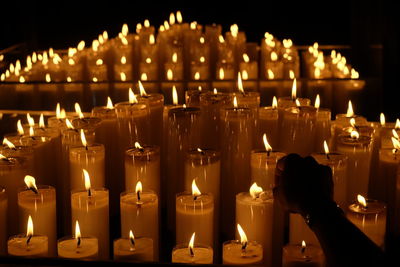 Candles burning on table in church