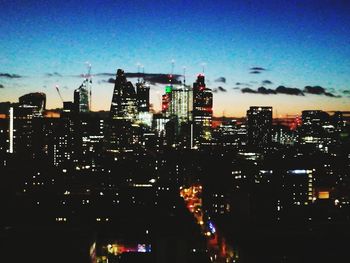 Aerial view of city lit up at night