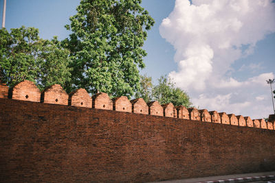 Low angle view of fort against cloudy sky