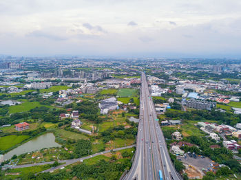 Aerial view of highway amidst buildings in city