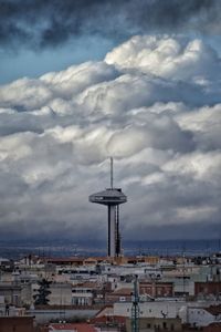 High angle view of buildings against cloudy sky
