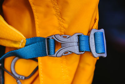 Close-up of a man holding yellow camera