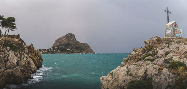 Panoramic view of sea and rock formations against sky