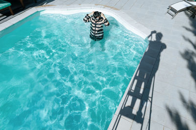 High angle view of man swimming in pool