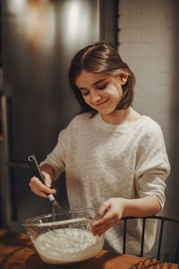 Side view of woman preparing food at home