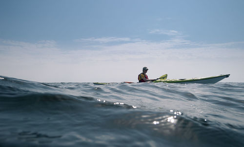 Man kayaking on the high seas