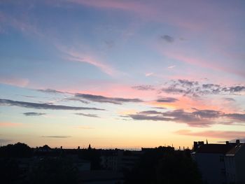 Silhouette cityscape against sky during sunset