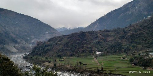 Scenic view of landscape and mountains against sky