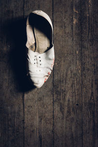 High angle view of shoes hanging on wooden floor