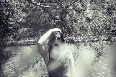 Woman looking at waterfall in forest