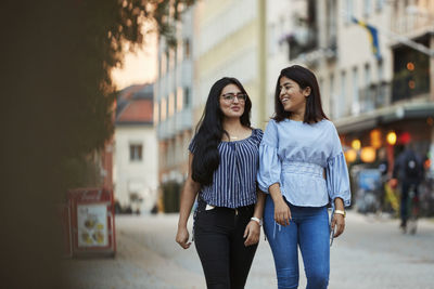 Female friends walking on street