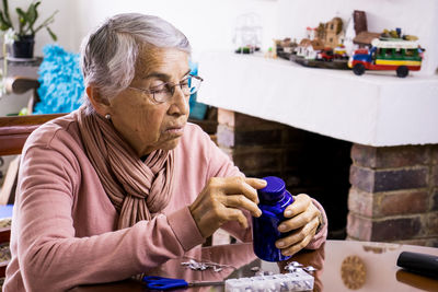 Midsection of man with coffee and woman sitting at table