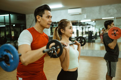 Side view of man exercising in gym