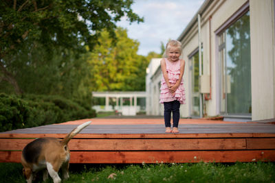 Full length portrait of girl standing on floorboard