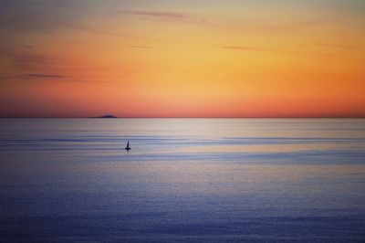 Scenic view of sea against sky at sunset