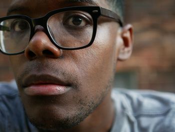 Close-up portrait of young man wearing eyeglasses