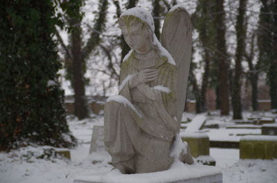 Statue against trees