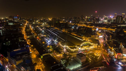 Illuminated cityscape against sky at night