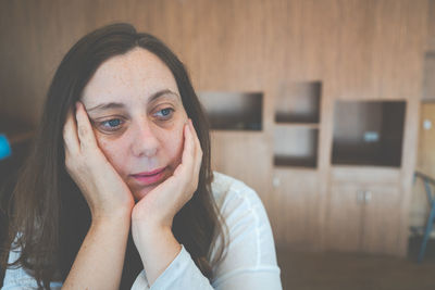 Close-up of depressed woman at home