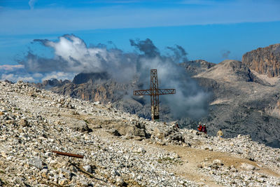 Panoramic view of cross on land against sky