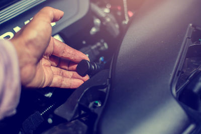 Cropped hand of man repairing car