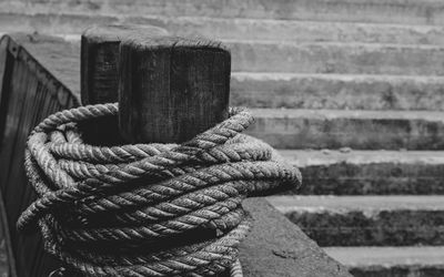 Close-up of rope tied to wooden post