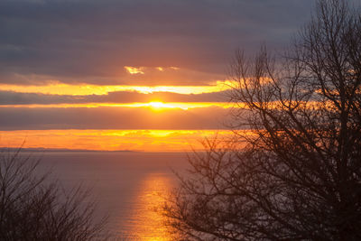 Scenic view of sea against romantic sky at sunset