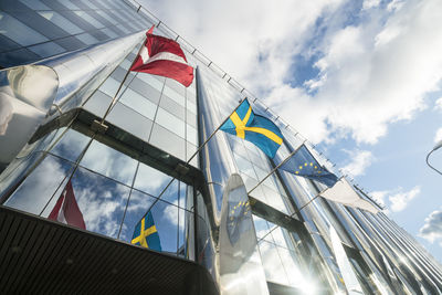 Modern hotel facade with scandinavian and eu flag