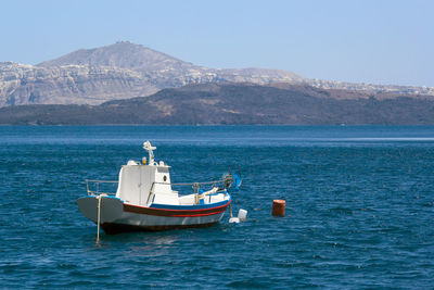 Boat sailing in sea against sky