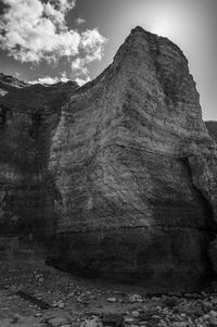 Low angle view of rock formation against sky