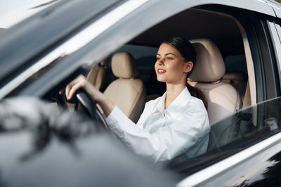 Portrait of young woman in car
