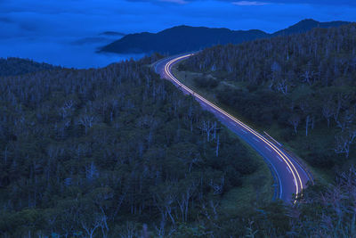 High angle view of road by mountain against sky