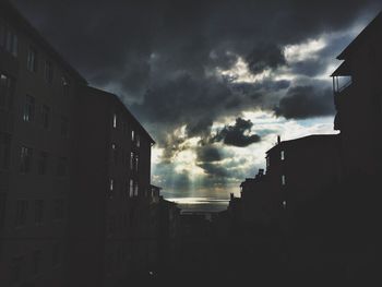 Low angle view of buildings against cloudy sky