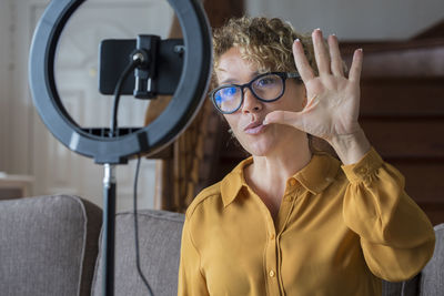 Close-up of woman holding camera