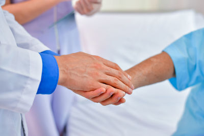 Cropped image of doctor consoling patient at hospital