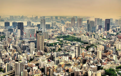 High angle view of modern buildings in city against sky