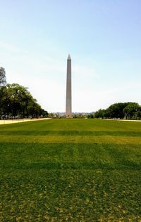 View of tower on field against sky