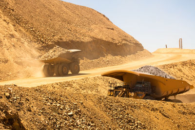 Huge dump trucks loaded with mineral in a copper mine in chile.