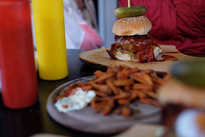 Burger on serving tray at table