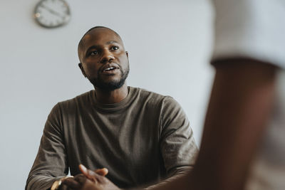 Male school counselor advising student at high school