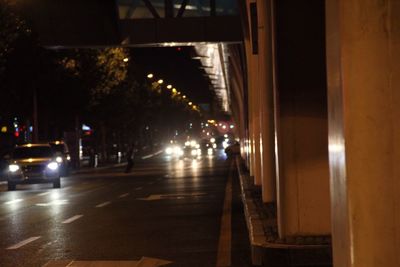 Illuminated street light on road at night