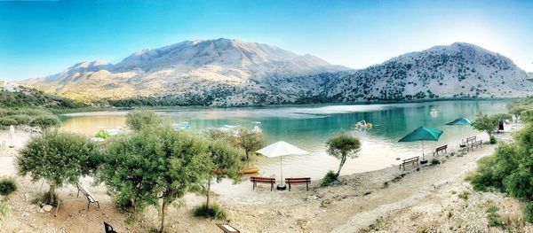 Scenic view of lake and mountains against sky