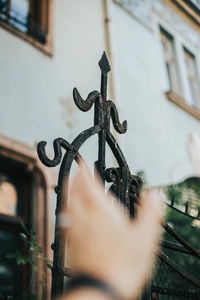 Close-up of metal fence against building