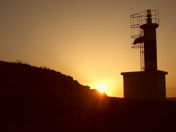 Silhouette of built structure at sunset