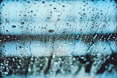 Full frame shot of wet glass window in rainy season