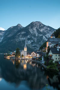 Illuminated buildings in city at waterfront