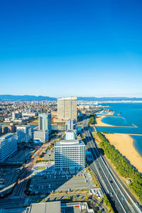 High angle view of buildings against blue sky