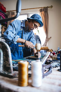 Side view of man working on table