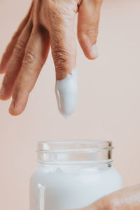 Man dipping finger in cream